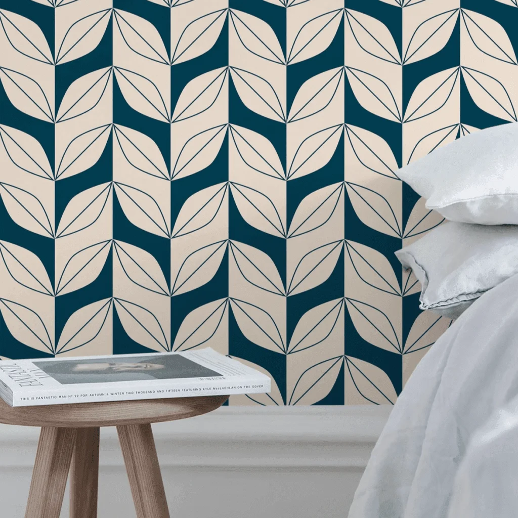 geometric green leaf wallpaper behind bed and nightstand