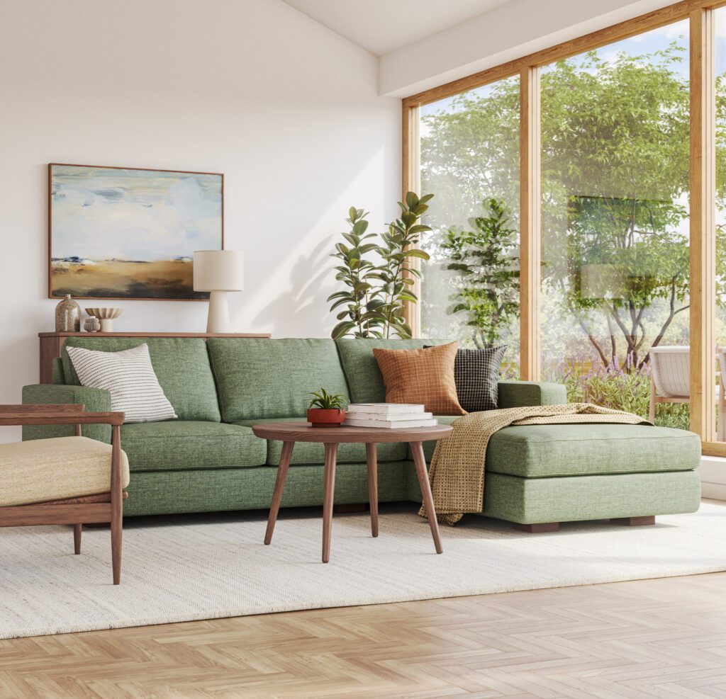 green sofa with chaise lounge next to large window