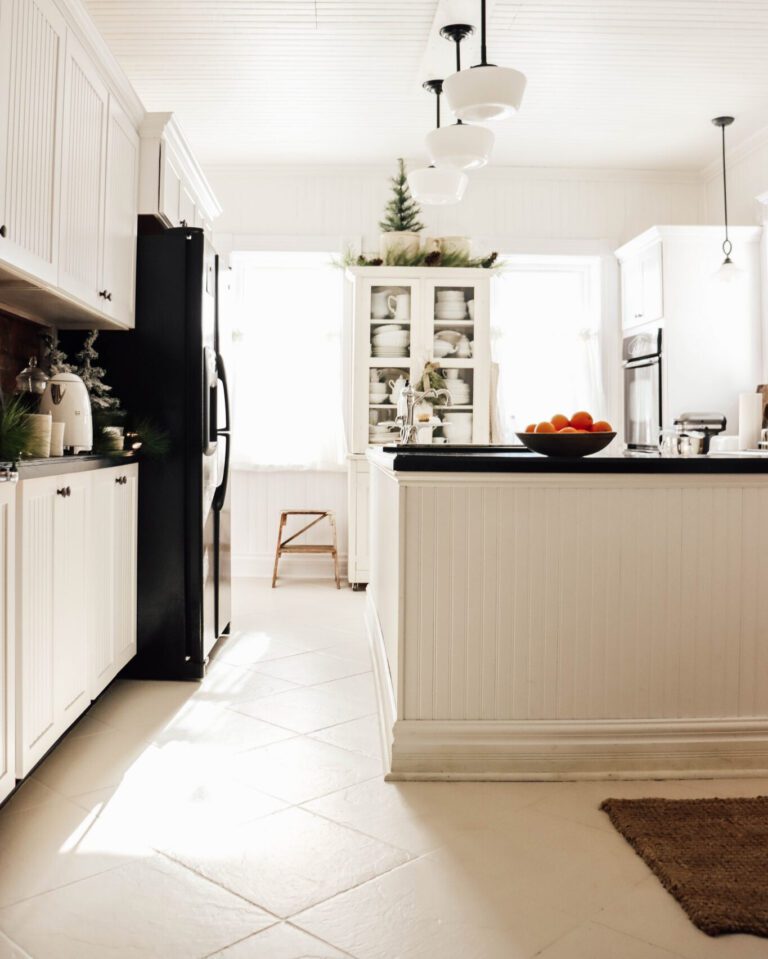 white and black kitchen with painted white tile floor