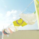 different colored underwear on clothes line with sky in background