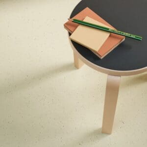 cream linoleum flooring with accent table with a black top and neutral colored legs