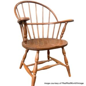 Wooden windsor chair against a white background