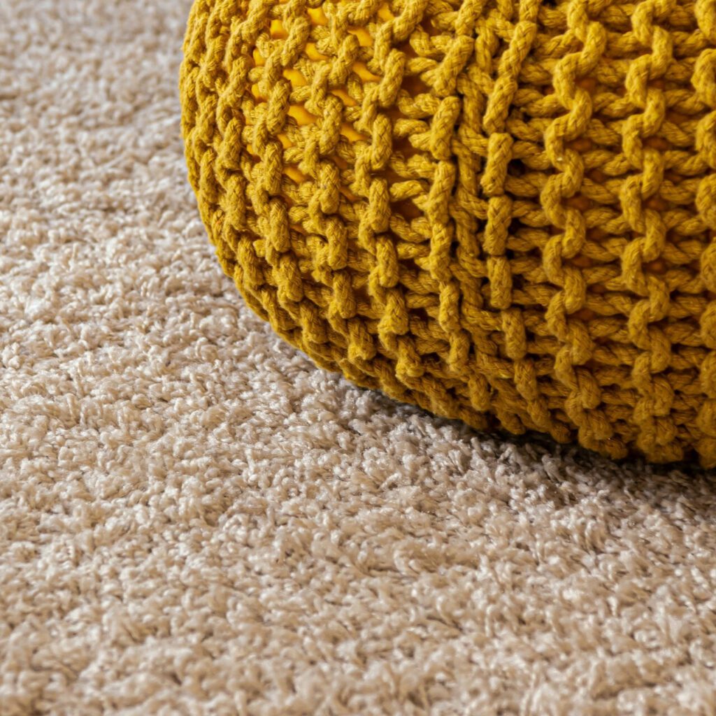 carpet with yellow knit pouf
