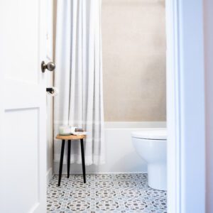 eco-friendly bathroom renovation with cream shower tile and white curtain