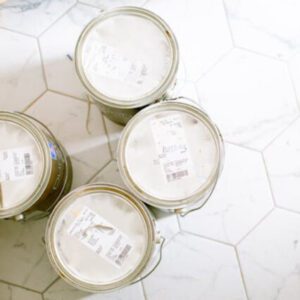 white paint cans on white tile floor