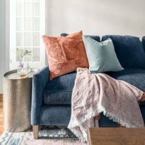 blue sofa with pink and blue pillows